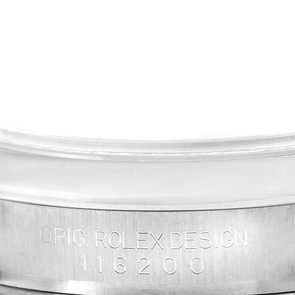 This is a close-up of the case side of a Rolex Datejust 116200 Women's Stainless Steel Pink Dial 116200 Women's Stainless Steel Pink Dial showing the model number and "ORIG. ROLEX DESIGN" engraving.