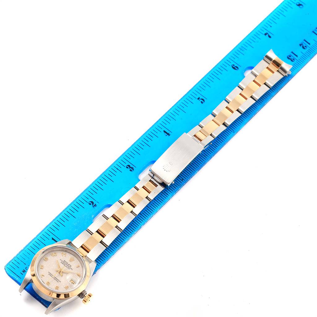 The image shows the Rolex Datejust 69163 Women's Stainless Steel Beige Dial 69163 Women's Stainless Steel Beige Dial watch laid flat with its band stretched next to a blue ruler for measurement.