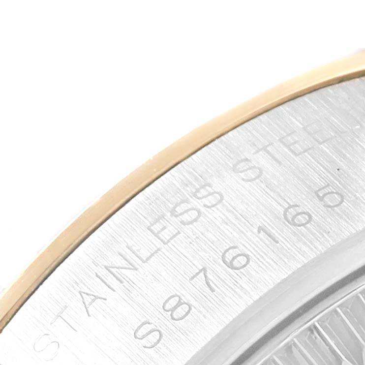 This close-up shows the stainless steel and gold bezel of a Rolex Datejust 69163 Women's Stainless Steel Beige Dial 69163 Women's Stainless Steel Beige Dial watch, along with part of the serial engraving.