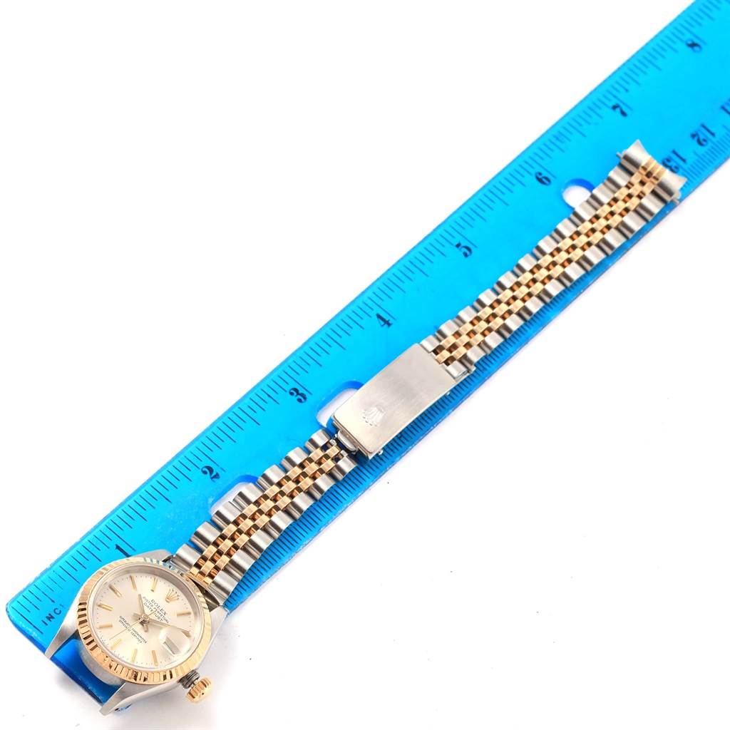 The image shows a Rolex Datejust 69173 Women's Stainless Steel Silver Dial 69173 Women's Stainless Steel Silver Dial watch laid flat on a blue ruler, displaying its face, band, and clasp.