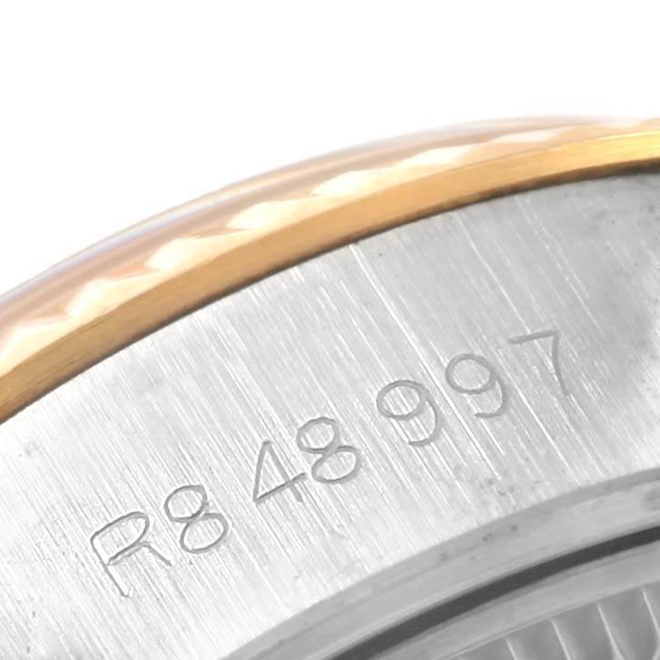The image shows a close-up of the side of a Rolex Datejust 69173 Women's Stainless Steel Silver Dial 69173 Women's Stainless Steel Silver Dial watch, focusing on the serial number engraved on the case.