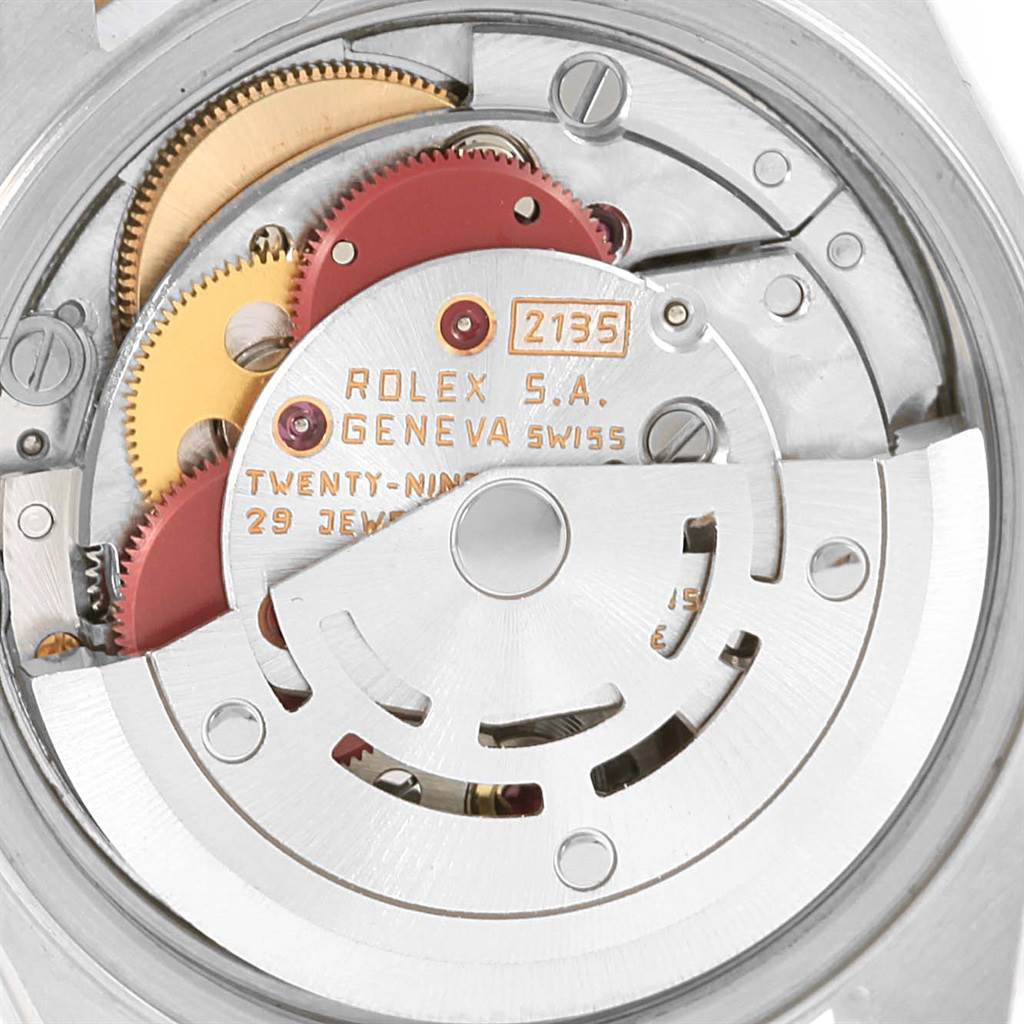 The image shows the movement and internal mechanism of a Rolex Datejust 69173 Women's Stainless Steel Silver Dial 69173 Women's Stainless Steel Silver Dial watch, highlighting gears and inscriptions.
