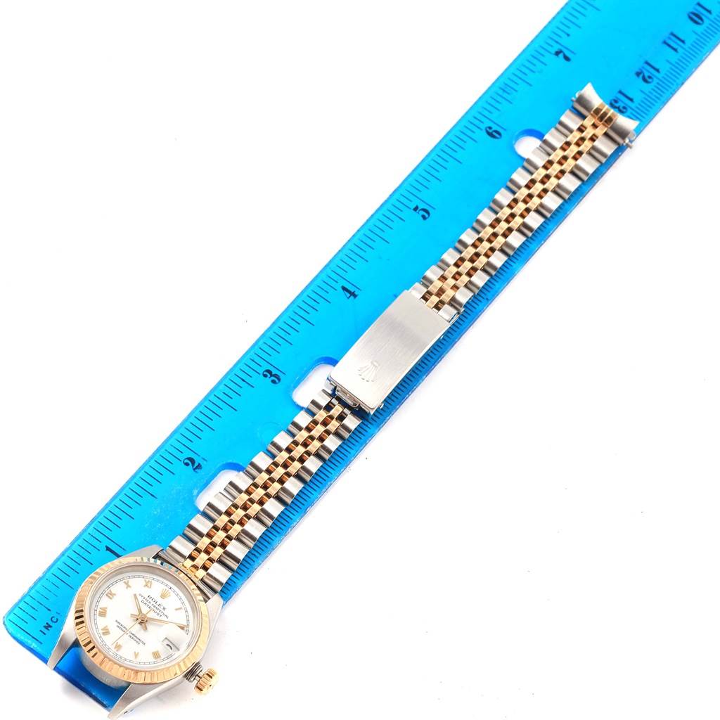 The image shows a Rolex Datejust 69173 Women's Stainless Steel White Dial 69173 Women's Stainless Steel White Dial watch laid flat alongside a ruler, highlighting the bracelet and clasp.