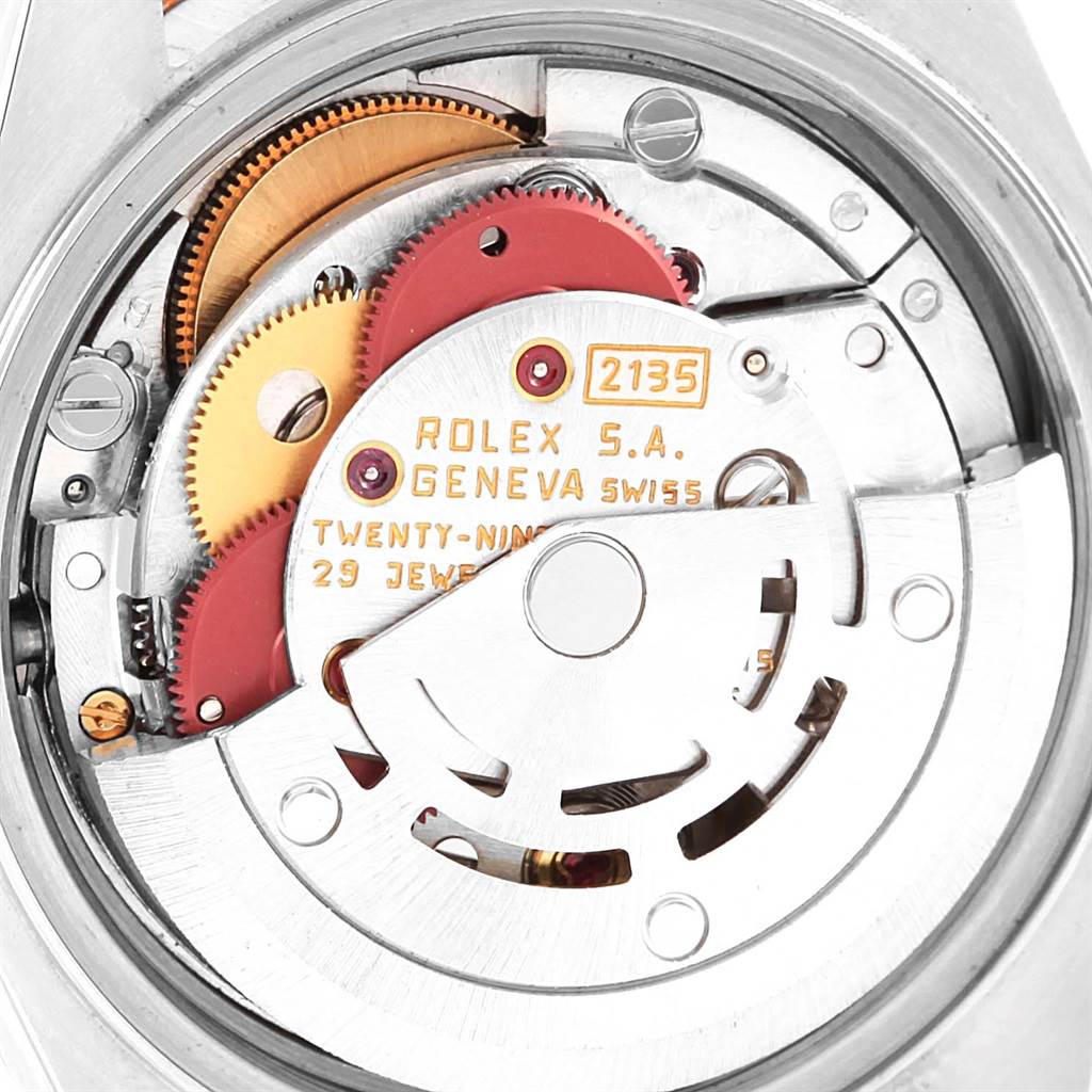 The image shows a close-up of the internal mechanism of a Rolex Datejust 69173 Women's Stainless Steel White Dial 69173 Women's Stainless Steel White Dial watch, featuring gears and the automatic rotor.