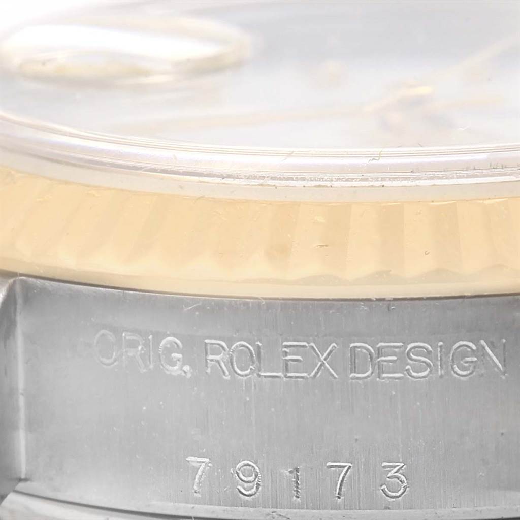 The image shows a close-up of the bezel and case side of a Rolex Datejust 79173 Women's Steel and Gold (two tone) White Dial 79173 Women's Steel and Gold (two tone) White Dial watch, highlighting its "ORIG. ROLEX DESIGN" engraving and model number "79173."