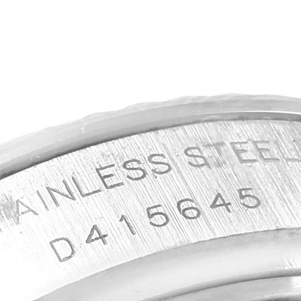 This image shows a close-up of the caseback edge of a Rolex Datejust 179174 Women's Stainless Steel White Dial 179174 Women's Stainless Steel White Dial, highlighting the engraved serial number and "stainless steel" text.