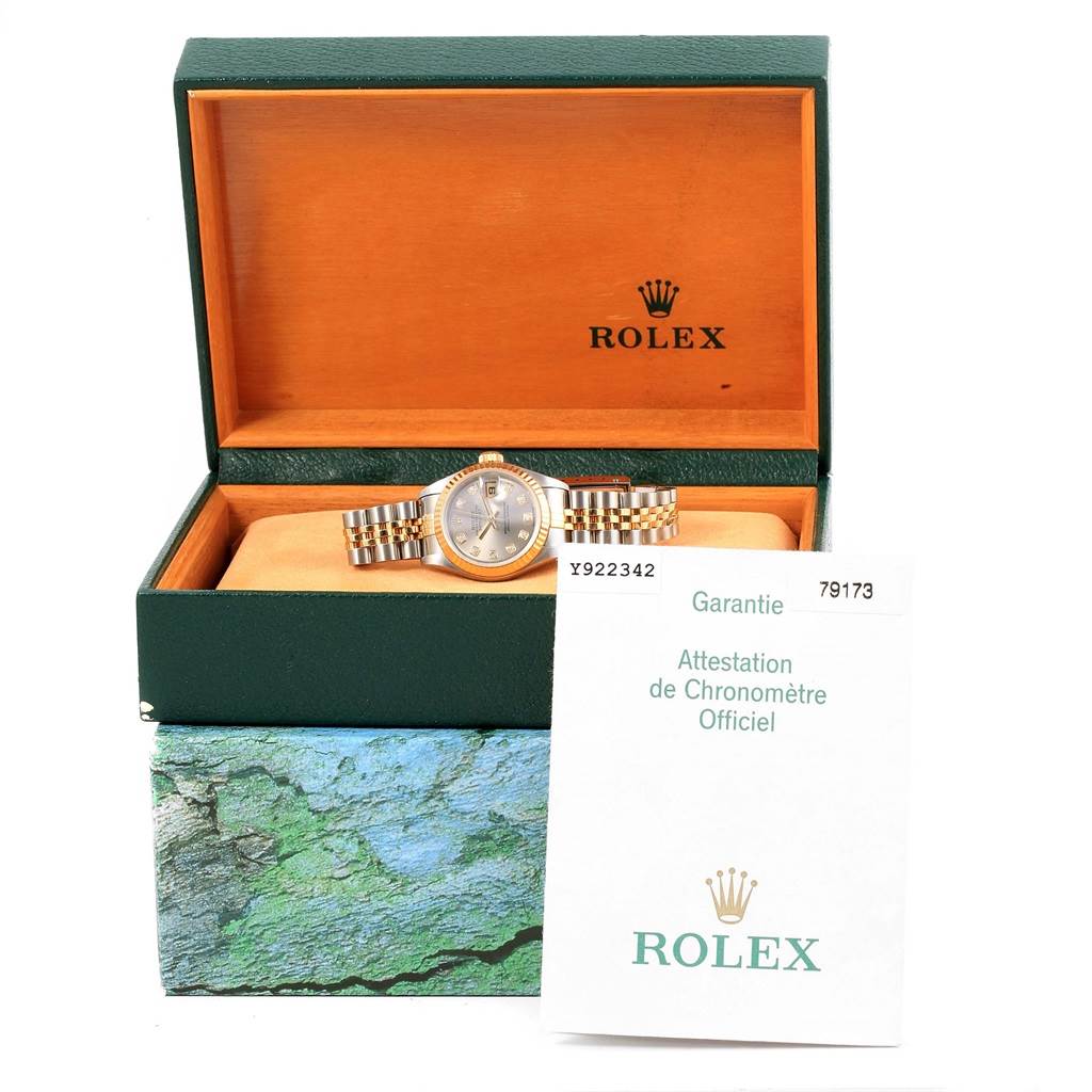 The image shows a Rolex Datejust 79173 Women's Stainless Steel Silver Dial 79173 Women's Stainless Steel Silver Dial watch in its open box, along with the warranty booklet, viewed from the front.