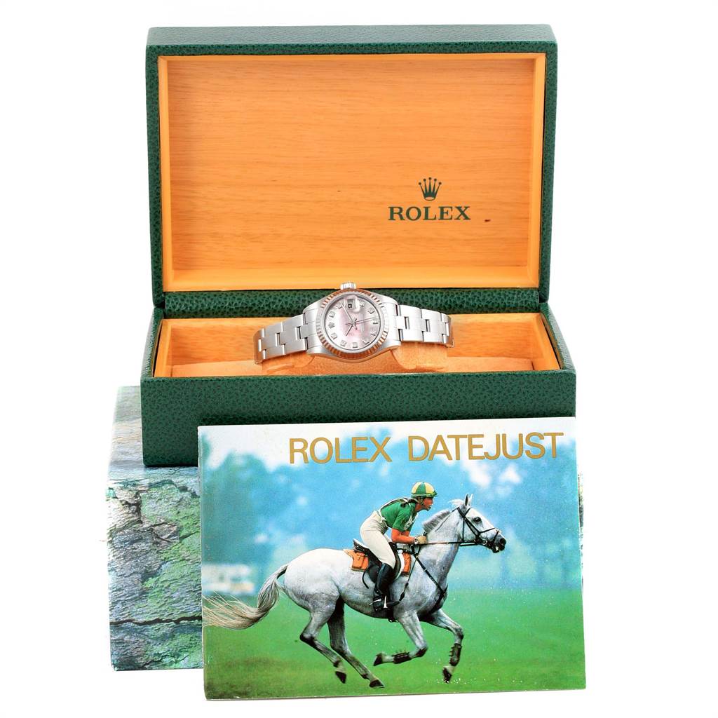 The image shows a Rolex Datejust 79174 Women's Stainless Steel Mother of Pearl Dial 79174 Women's Stainless Steel Mother of Pearl Dial watch from a front angle inside its open box, with a booklet titled "Rolex Datejust 79174 Women's Stainless Steel Mother of Pearl Dial 79174 Women's Stainless Steel Mother of Pearl Dial" in front.