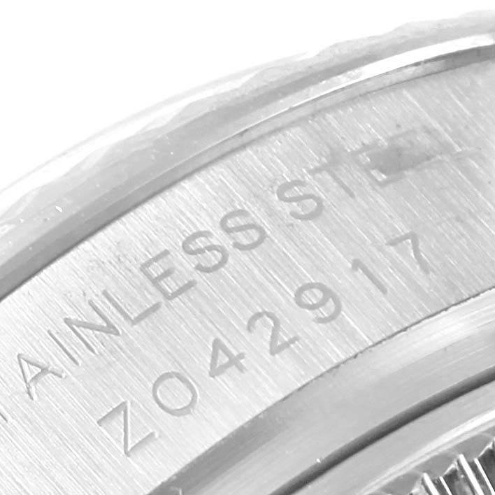 This close-up shows the engraved serial number and "STAINLESS STEEL" marking on the caseback of a Rolex Datejust 179174 Women's Stainless Steel Silver Dial 179174 Women's Stainless Steel Silver Dial watch.