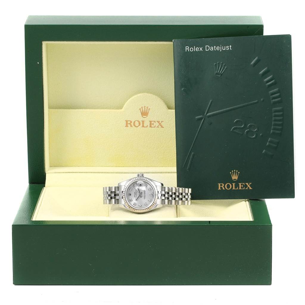 This image shows a Rolex Datejust 179174 Women's Stainless Steel Silver Dial 179174 Women's Stainless Steel Silver Dial watch and its manual, placed inside the open presentation box.
