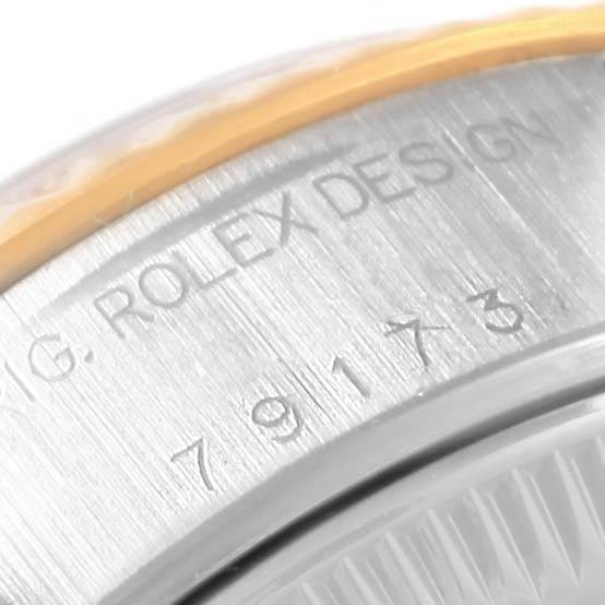 The image shows an angled close-up of the bezel and outer edge of the dial of a Rolex Datejust 79173 Women's Stainless Steel Black Dial 79173 Women's Stainless Steel Black Dial watch, highlighting the engraved markings.