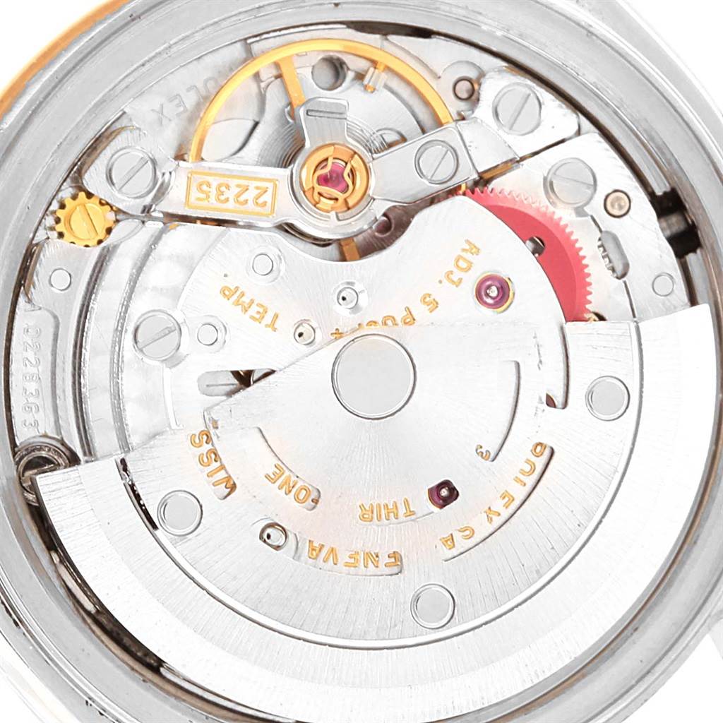 This image shows a close-up of the movement mechanism of a Rolex Datejust 79173 Women's Stainless Steel Black Dial 79173 Women's Stainless Steel Black Dial watch, including gears and engravings.