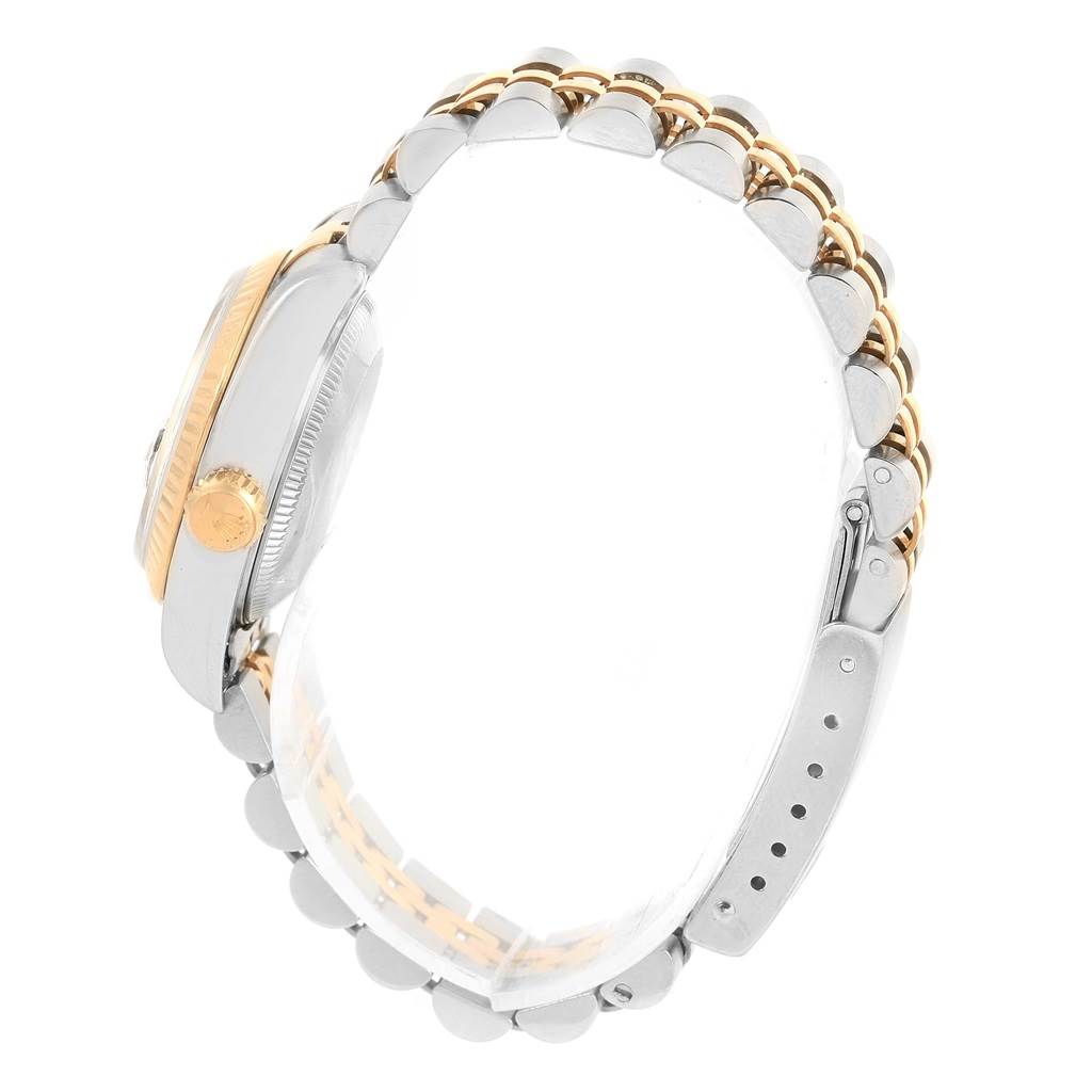 This side view of the Rolex Datejust 69173 Women's Stainless Steel Black Dial 69173 Women's Stainless Steel Black Dial watch features the bezel, crown, and part of the bracelet.