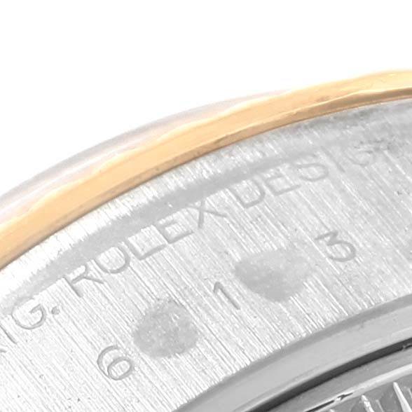 This close-up image of a Rolex Datejust 69173 Women's Stainless Steel Black Dial 69173 Women's Stainless Steel Black Dial watch shows part of the bezel and a section of the engraved text on the case back.