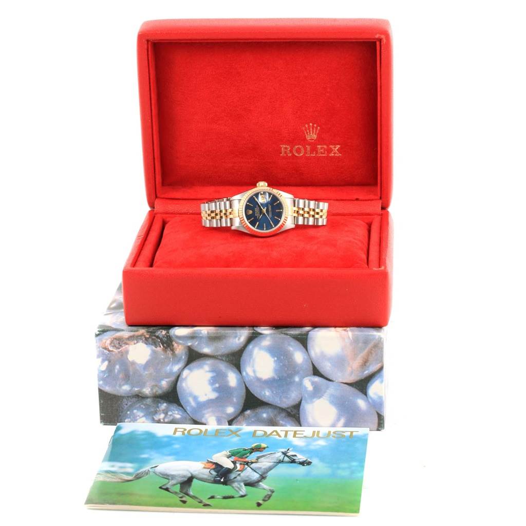 The image shows a Rolex Datejust 69173 Women's Stainless Steel Blue Dial 69173 Women's Stainless Steel Blue Dial watch placed inside a red Rolex display box with warranty and manual booklets.