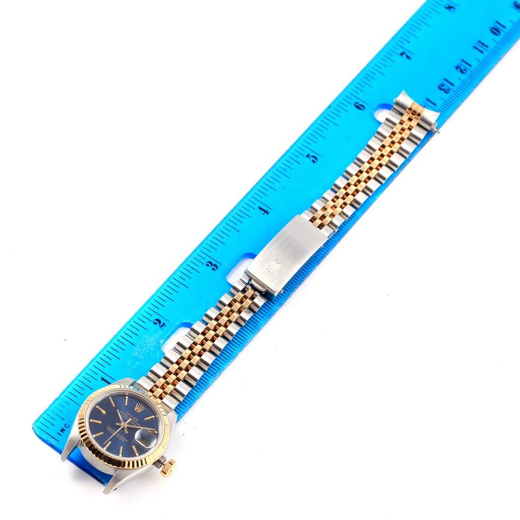 The image shows a Rolex Datejust 69173 Women's Stainless Steel Blue Dial 69173 Women's Stainless Steel Blue Dial watch laid flat next to a ruler, displaying the dial, bezel, and bracelet clasp.