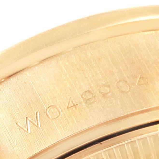 This image shows a close-up of the Rolex Datejust 69238 Women's Yellow Gold Silver Dial 69238 Women's Yellow Gold Silver Dial model's case back, highlighting the serial number engraving.