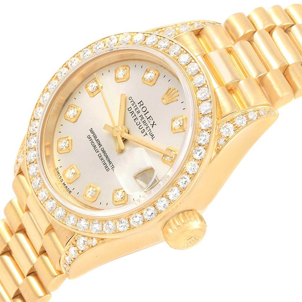 The image shows a Rolex Datejust 69238 Women's Yellow Gold Silver Dial 69238 Women's Yellow Gold Silver Dial watch at an angle, displaying its diamond-encrusted bezel, dial, and part of the bracelet.