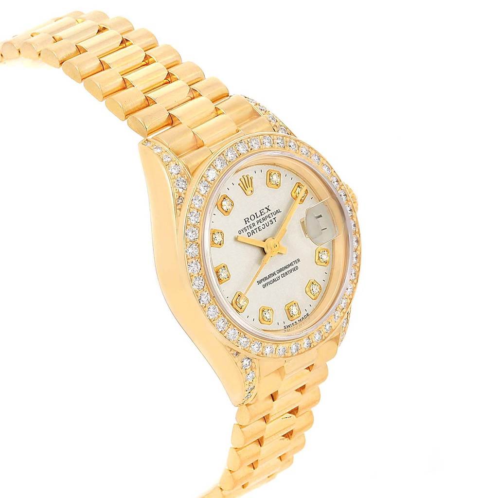 The image shows a side angle of the Rolex Datejust 69238 Women's Yellow Gold Silver Dial 69238 Women's Yellow Gold Silver Dial watch, highlighting its gold band, diamond bezel, and face with date display.