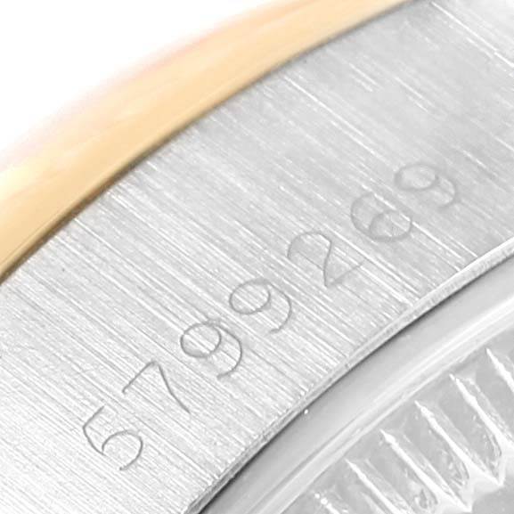 This close-up shows the serial number engraved on the metal casing of a Rolex Datejust 6917 Women's Stainless Steel Champagne Dial 6917 Women's Stainless Steel Champagne Dial watch.