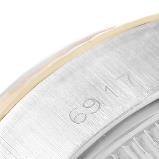 The image shows a close-up angle of the Rolex Datejust 6917 Women's Stainless Steel Champagne Dial 6917 Women's Stainless Steel Champagne Dial model's case with visible engravings.