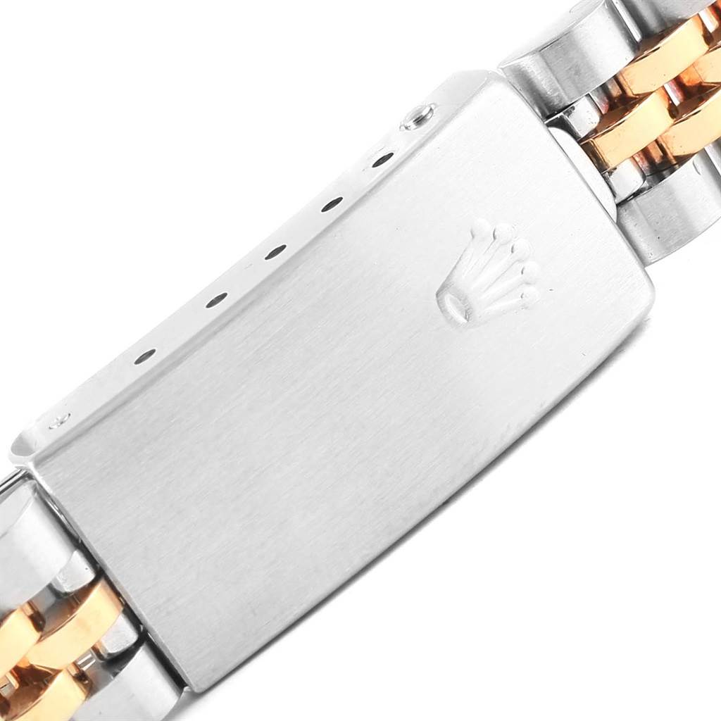 This image shows a close-up of the clasp of the Rolex Datejust 69173 Women's Stainless Steel Champagne Dial 69173 Women's Stainless Steel Champagne Dial watch bracelet, featuring a mix of silver and gold tones.