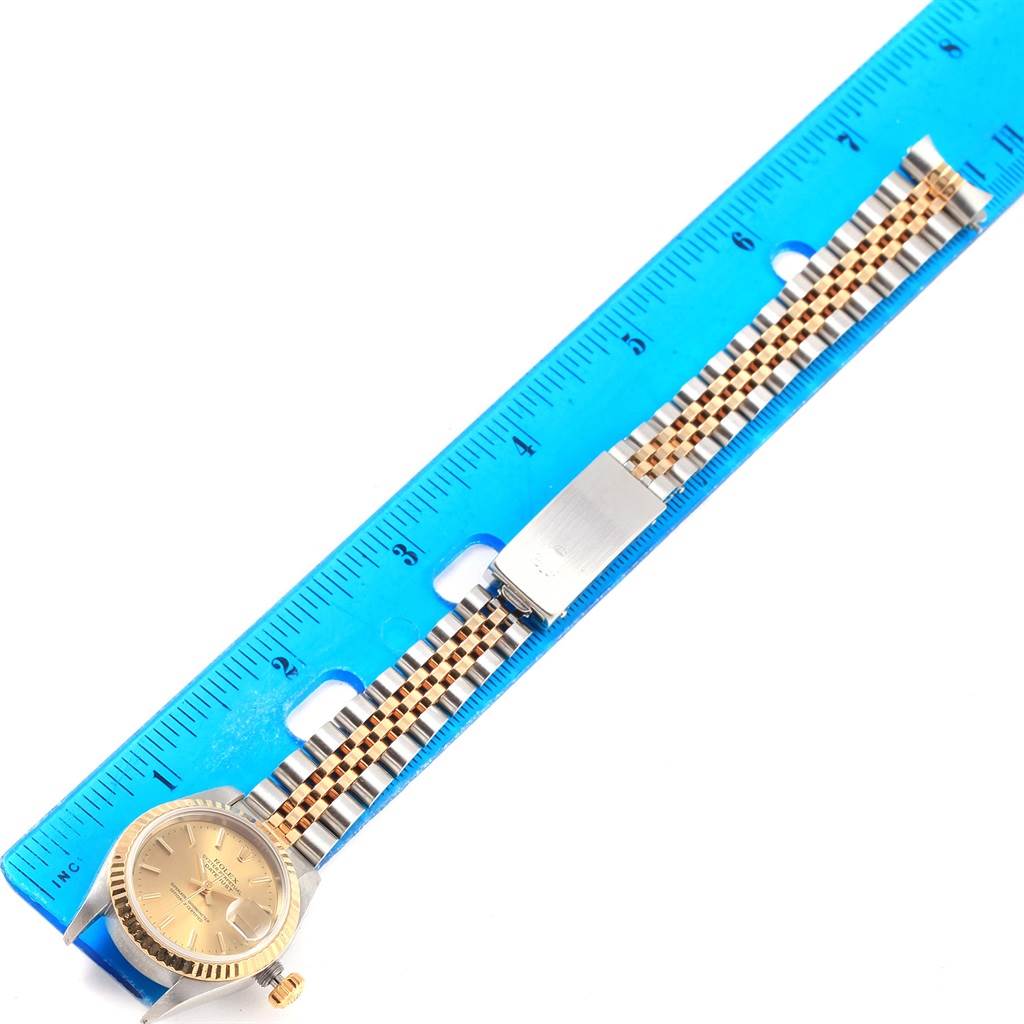 The image shows a Rolex Datejust 69173 Women's Stainless Steel Champagne Dial 69173 Women's Stainless Steel Champagne Dial watch from a top angle, featuring the dial, bezel, and bracelet aligned next to a blue ruler.