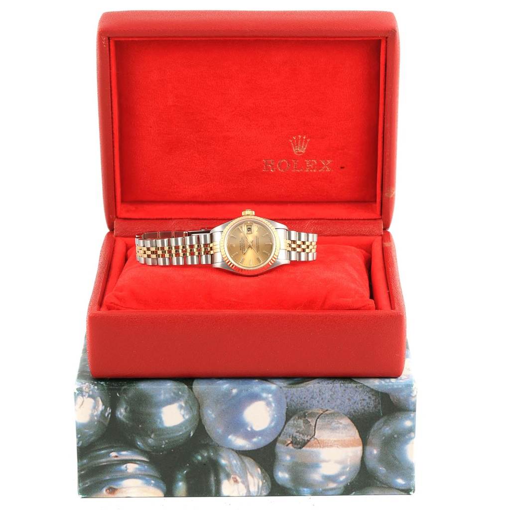 This Rolex Datejust 69173 Women's Stainless Steel Champagne Dial 69173 Women's Stainless Steel Champagne Dial watch is shown from the front, inside its red branded box, displaying its face and bracelet.