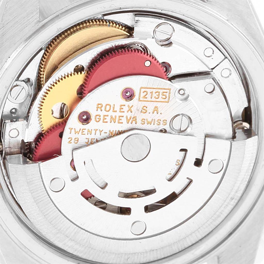 This image shows a close-up view of the movement mechanism inside a Rolex Datejust 69173 Women's Stainless Steel Champagne Dial 69173 Women's Stainless Steel Champagne Dial watch, highlighting gears and intricate components.