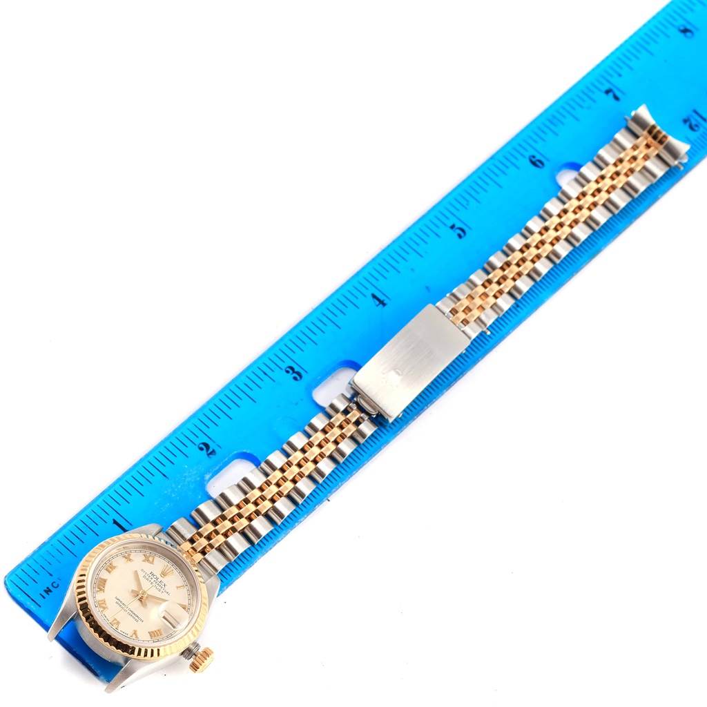 The image shows a Rolex Datejust 69173 Women's Stainless Steel Beige Dial 69173 Women's Stainless Steel Beige Dial watch laid flat against a ruler, highlighting the face, bracelet, and clasp.