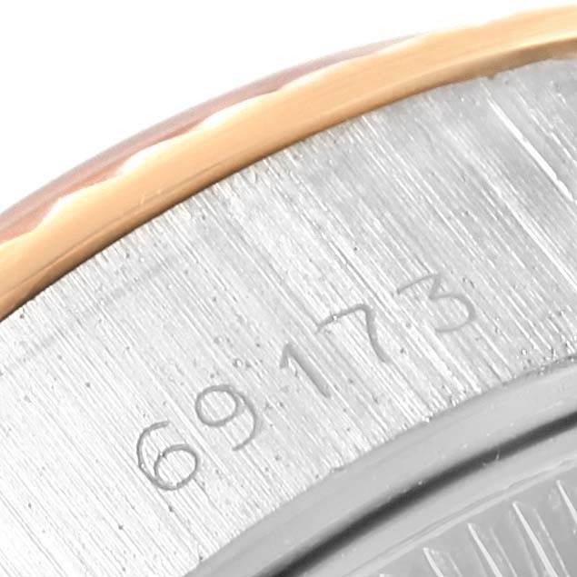 This close-up image of the Rolex Datejust 69173 Women's Stainless Steel Beige Dial 69173 Women's Stainless Steel Beige Dial watch shows part of the case with the model number engraved on it.