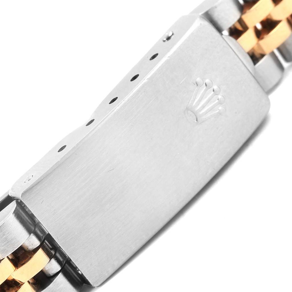 The image shows a close-up of the clasp of a Rolex Datejust 69173 Women's Stainless Steel White Dial 69173 Women's Stainless Steel White Dial watch band, featuring a two-tone metal design.