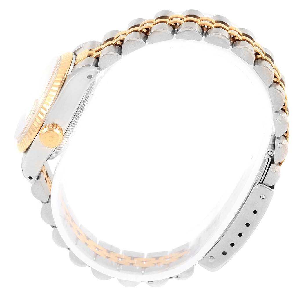 This image shows a side view of a Rolex Datejust 69173 Women's Stainless Steel Champagne Dial 69173 Women's Stainless Steel Champagne Dial watch, highlighting the crown, bezel, and two-tone bracelet.