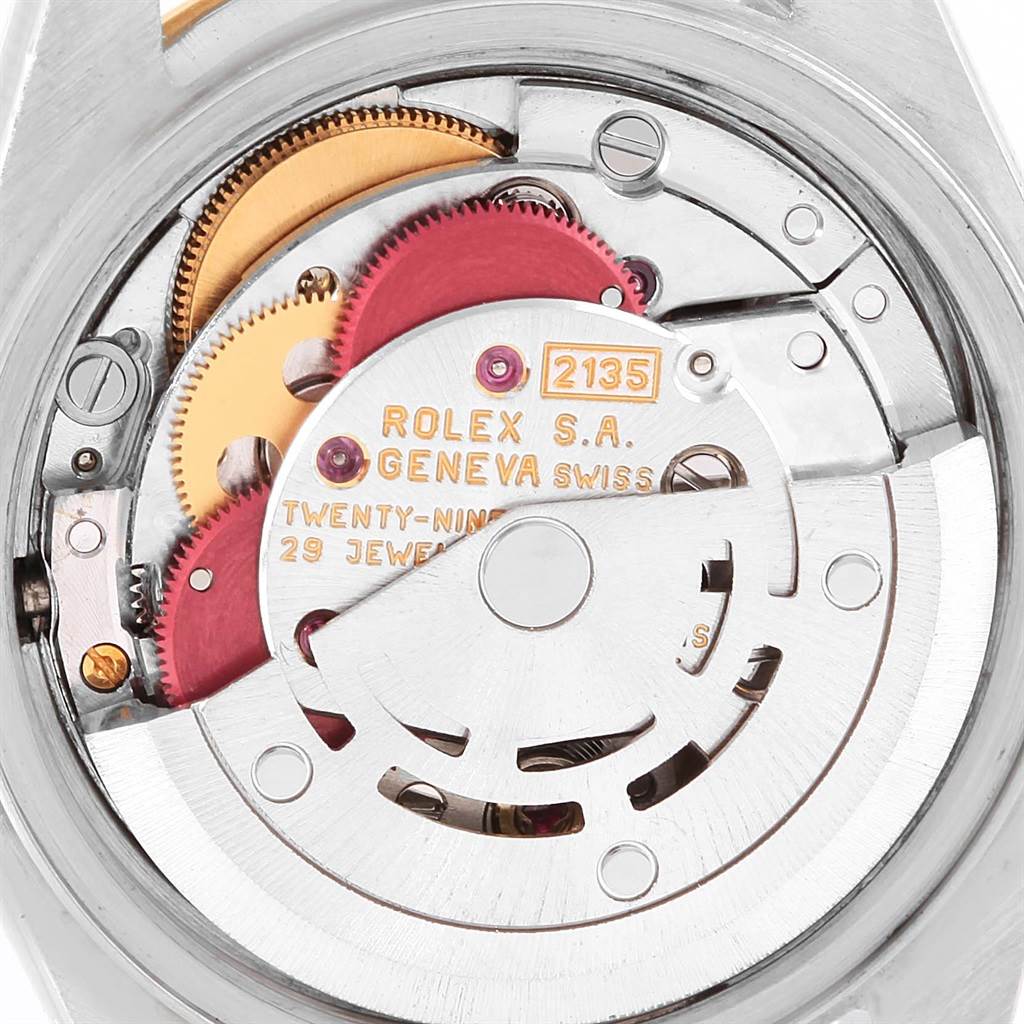 The image shows a close-up view of the movement mechanism of a Rolex Datejust 69173 Women's Stainless Steel Champagne Dial 69173 Women's Stainless Steel Champagne Dial watch, focusing on the gears and rotor.