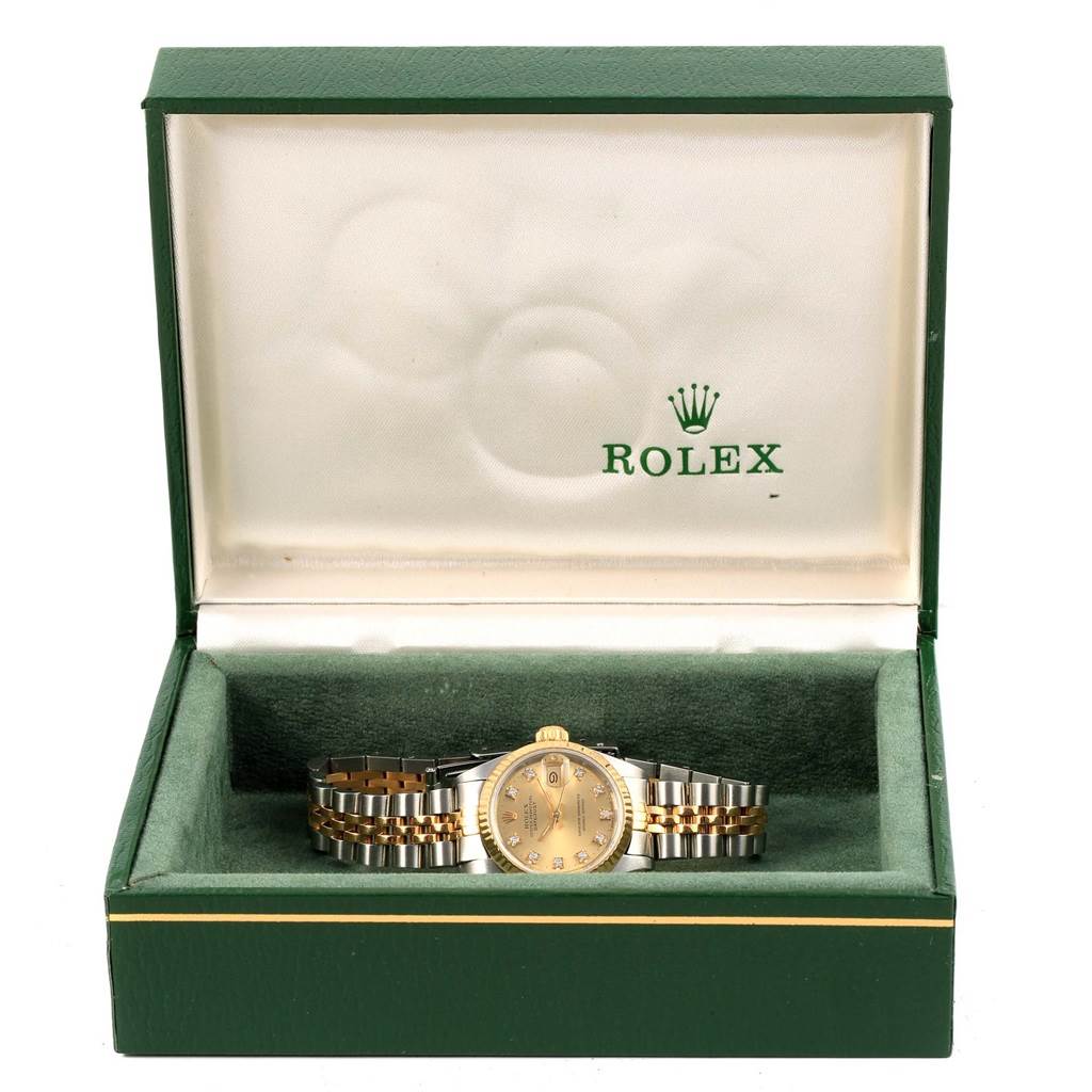 The Rolex Datejust 69173 Women's Stainless Steel Champagne Dial 69173 Women's Stainless Steel Champagne Dial watch is displayed in its green box, showing the face and bracelet at a front angle.