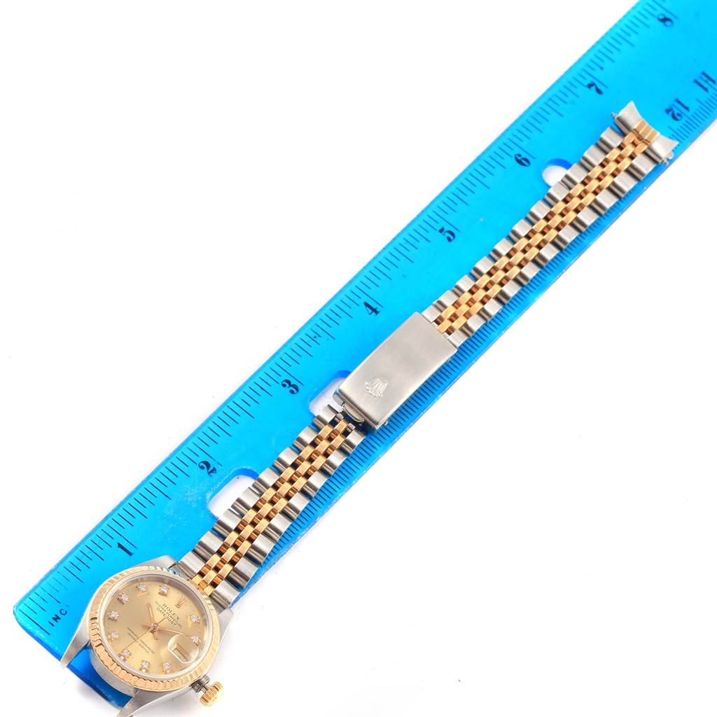 The image shows a Rolex Datejust 69173 Women's Stainless Steel Champagne Dial 69173 Women's Stainless Steel Champagne Dial watch laid flat, with a blue ruler beside it for scale, displaying the dial and jubilee bracelet.