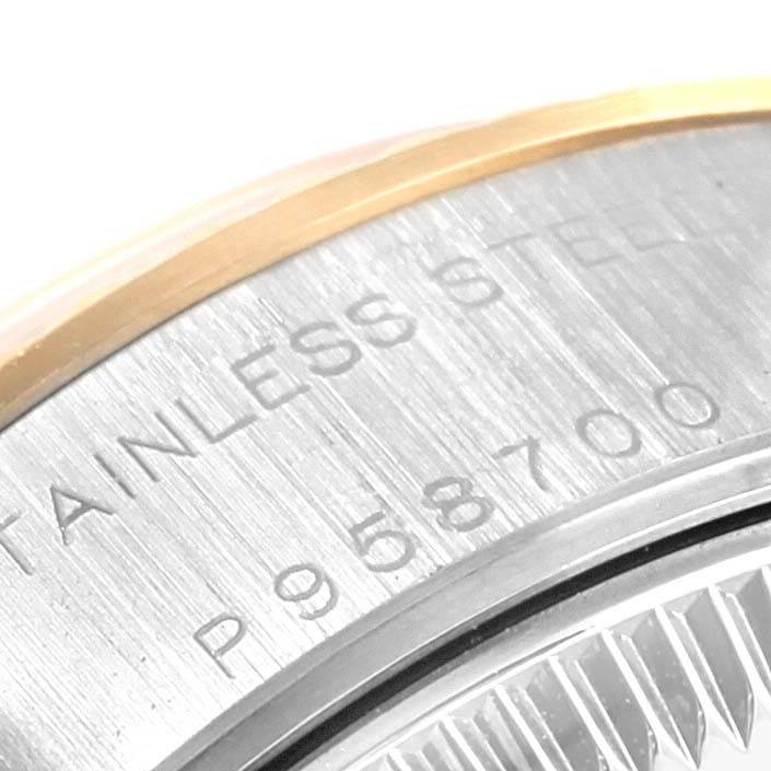 This is a close-up of the back and edge of a Rolex Datejust 79173 Women's Steel and Gold (two tone) Champagne Dial 79173 Women's Steel and Gold (two tone) Champagne Dial watch, showcasing its serial number and stainless steel marking.
