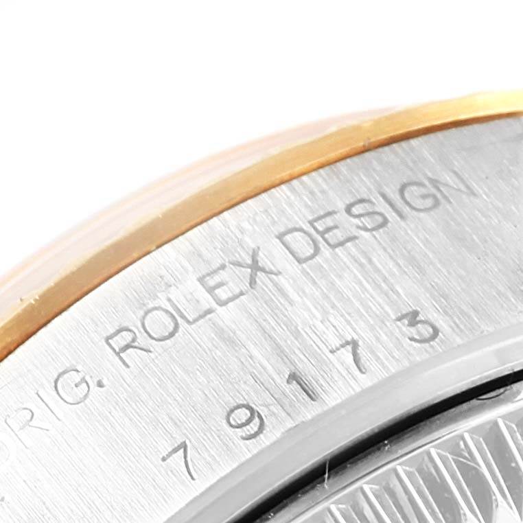 The image shows a close-up of the casing edge and engraving on a Rolex Datejust 79173 Women's Steel and Gold (two tone) Champagne Dial 79173 Women's Steel and Gold (two tone) Champagne Dial watch.