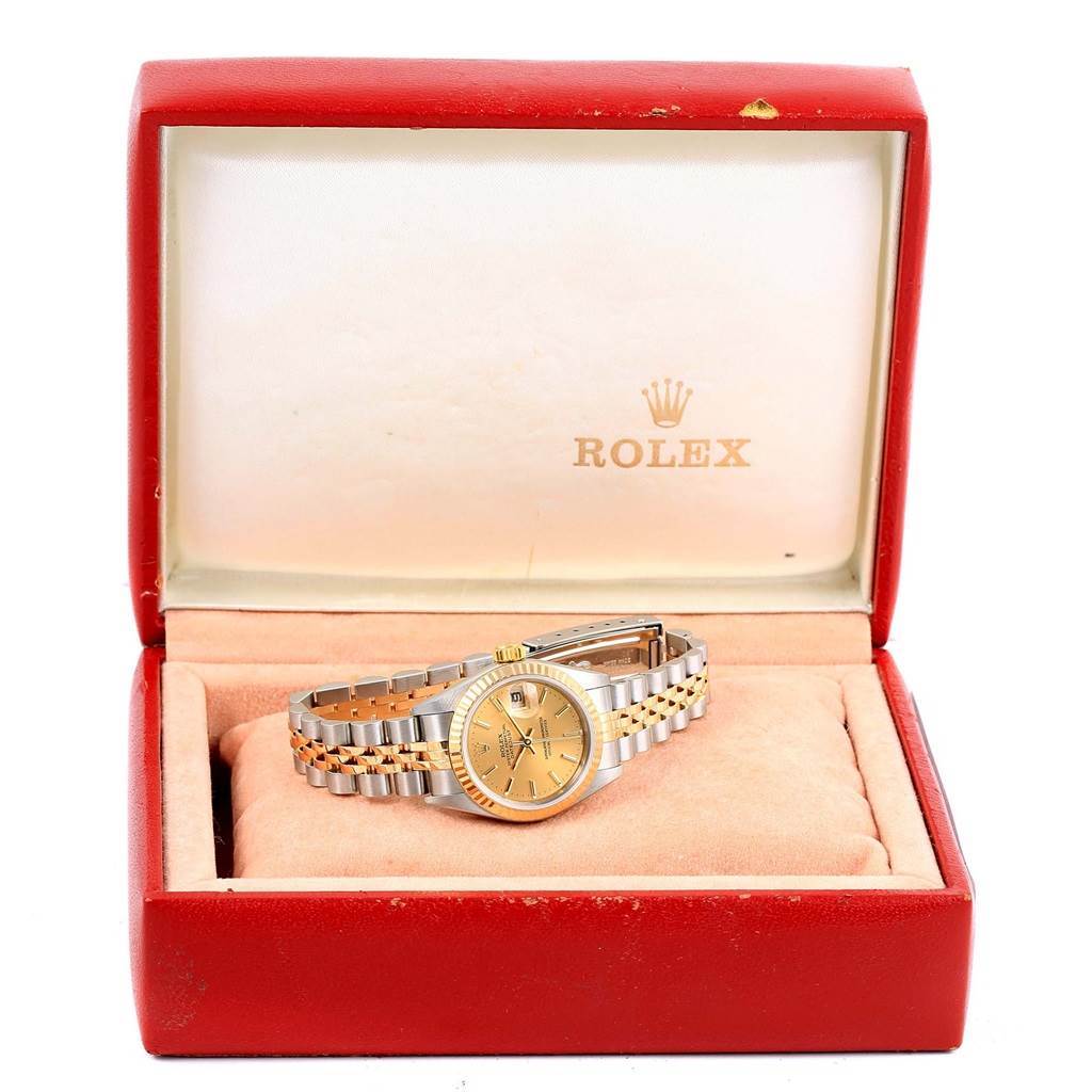 The Rolex Datejust 79173 Women's Steel and Gold (two tone) Champagne Dial 79173 Women's Steel and Gold (two tone) Champagne Dial watch is displayed at a front angle inside an open red box with a cushion.