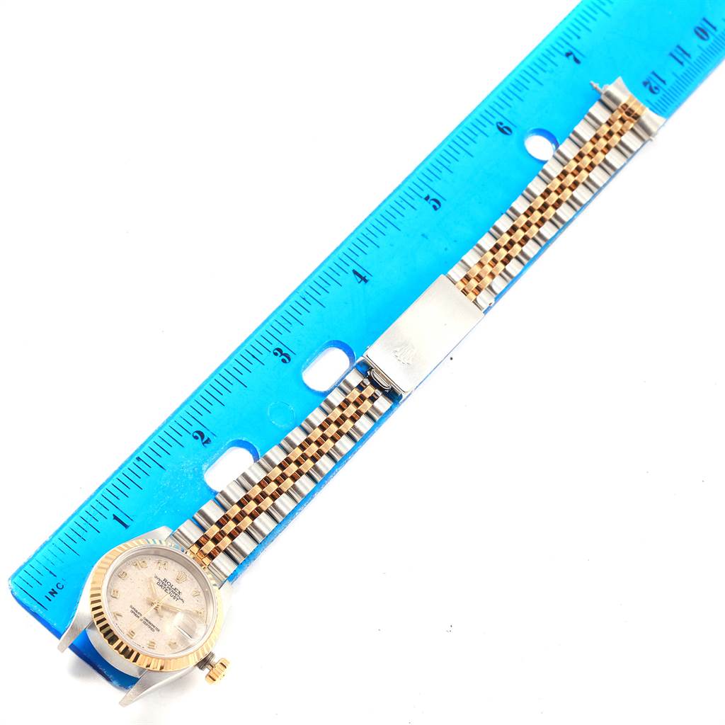 The image displays a Rolex Datejust 69173 Women's Stainless Steel Beige Dial 69173 Women's Stainless Steel Beige Dial watch, laid flat next to a blue ruler, showing the dial, bracelet, and clasp.