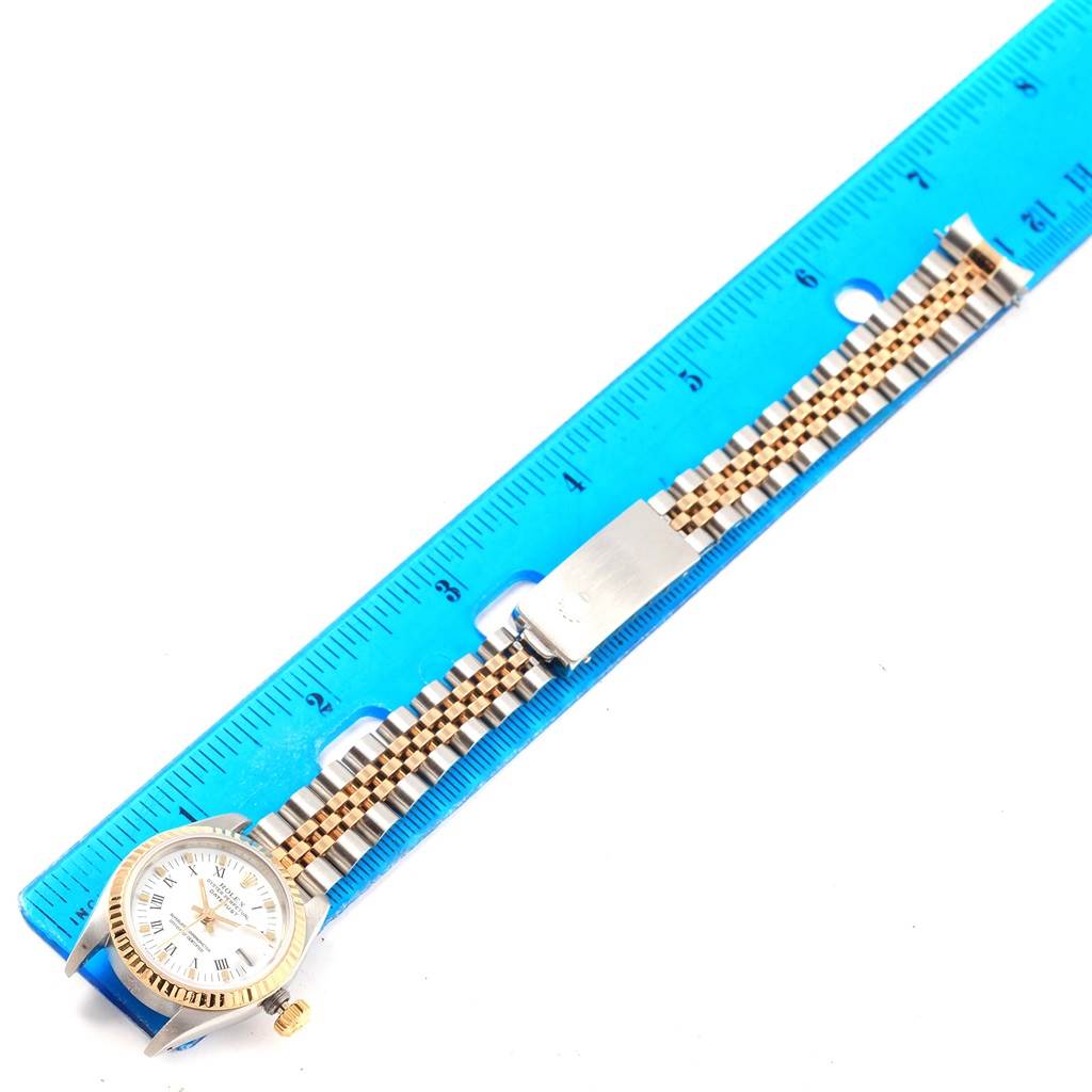 The Rolex Datejust 69173 Women's Stainless Steel White Dial 69173 Women's Stainless Steel White Dial watch is shown from the front, lying flat, with a ruler for scale.