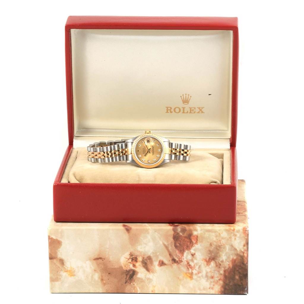 The Rolex Datejust 79173 Women's Stainless Steel Champagne Dial 79173 Women's Stainless Steel Champagne Dial watch is shown from the front in an open display box with a red exterior and beige interior.
