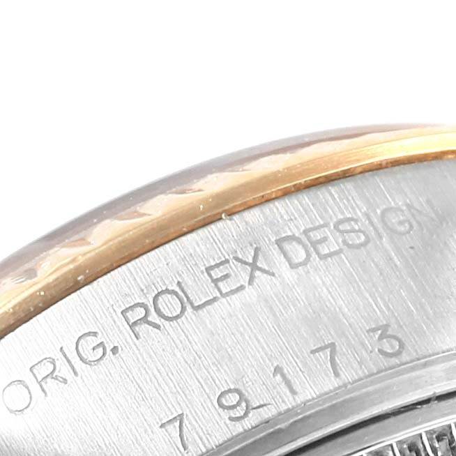 The image shows a close-up of the side of a Rolex Datejust 79173 Women's Stainless Steel Silver Dial 79173 Women's Stainless Steel Silver Dial model, highlighting the engraved branding and design details.