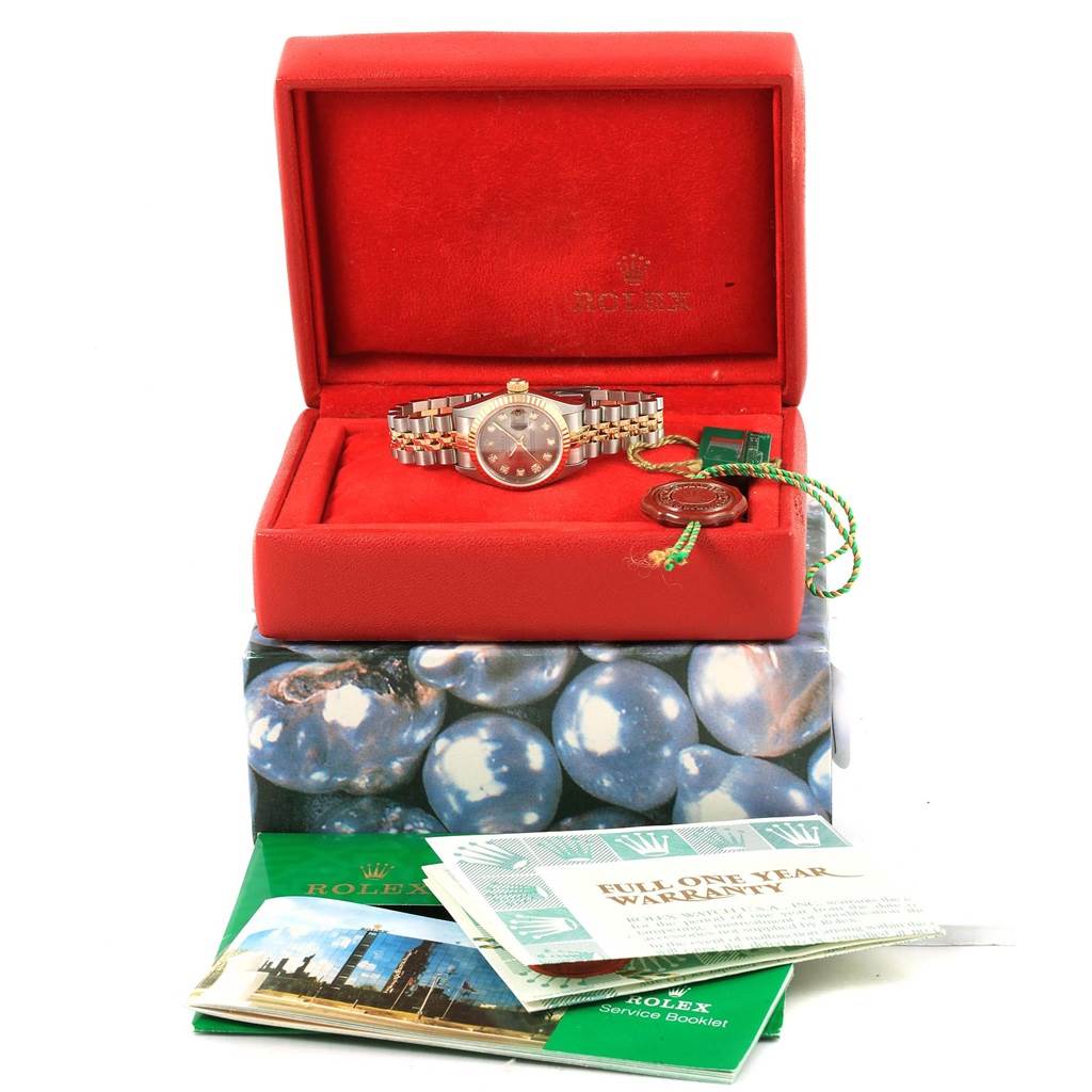 The image shows a Rolex Datejust 79173 Women's Stainless Steel Silver Dial 79173 Women's Stainless Steel Silver Dial watch from a front angle, inside its box, with accompanying warranty and service booklets.