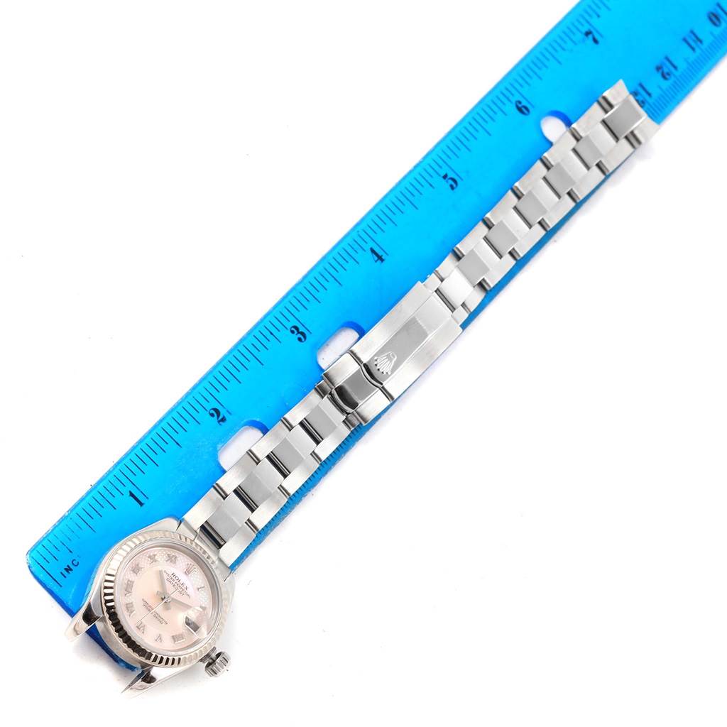 The image shows a top-down view of a Rolex Datejust 179174 Women's Stainless Steel Mother of Pearl Dial 179174 Women's Stainless Steel Mother of Pearl Dial watch with a closed clasp and a ruler for scale.