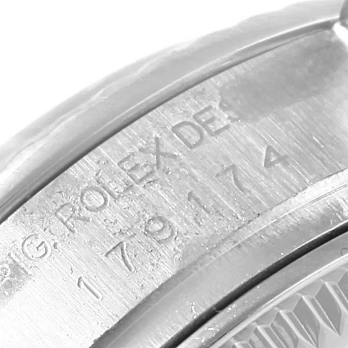 This image shows a close-up view of the engraved serial number and "ROLEX" branding on the watch case of a Rolex Datejust 179174 Women's Stainless Steel Mother of Pearl Dial 179174 Women's Stainless Steel Mother of Pearl Dial model.