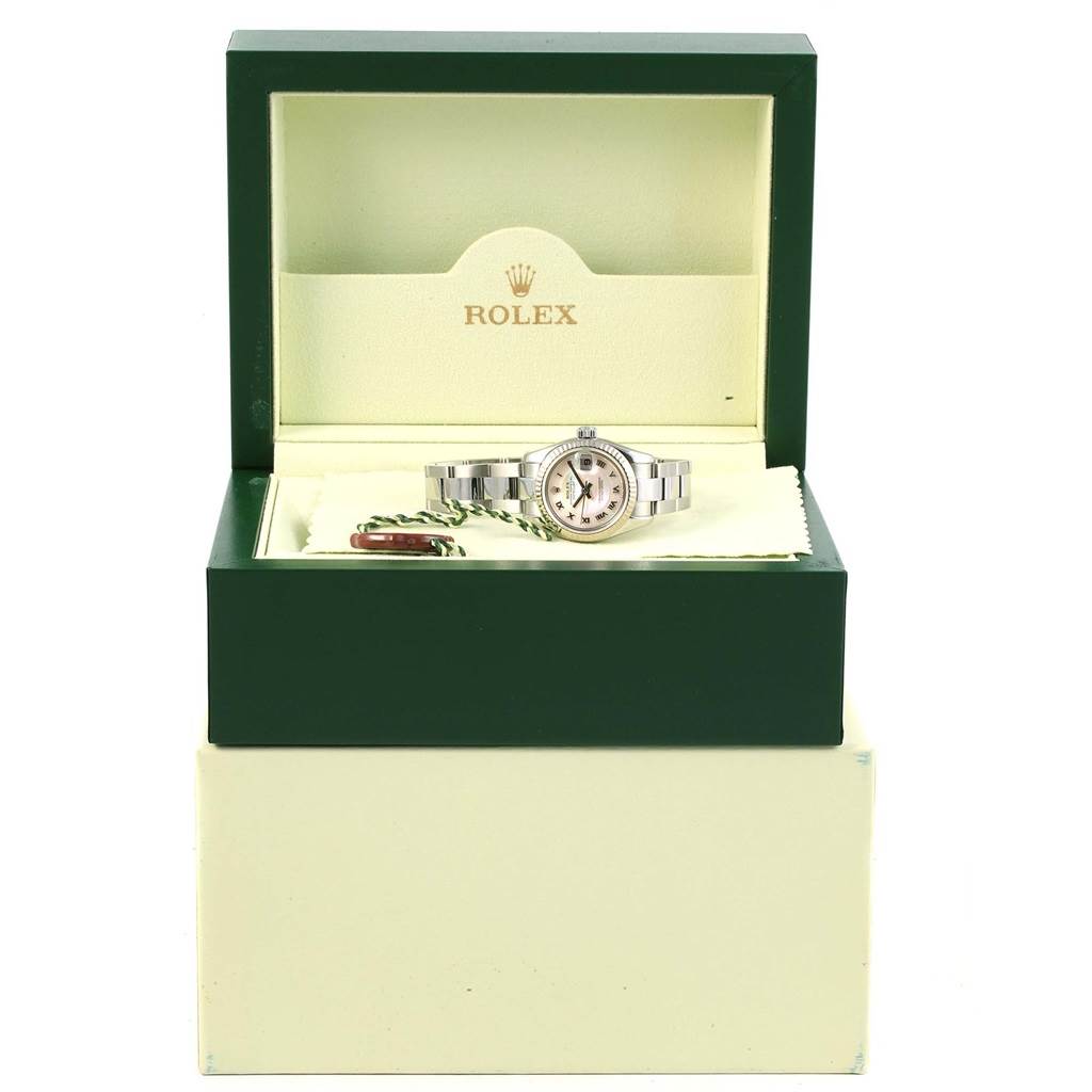 The Rolex Datejust 179174 Women's Stainless Steel Mother of Pearl Dial 179174 Women's Stainless Steel Mother of Pearl Dial watch is displayed front-on in its open green and cream box, with tags and cloth accessories.