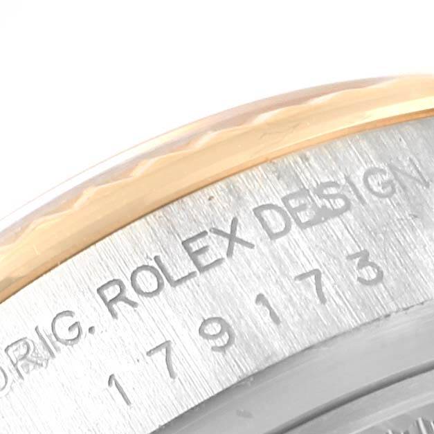 This image shows a close-up angle of the bezel and part of the case back with engraved text on the Rolex 179173 Men's Steel and Gold (two tone) Black Dial 179173 Men's Steel and Gold (two tone) Black Dial Datejust Steel Yellow Gold Diamond Ladies Watch 179173 Box Card model.