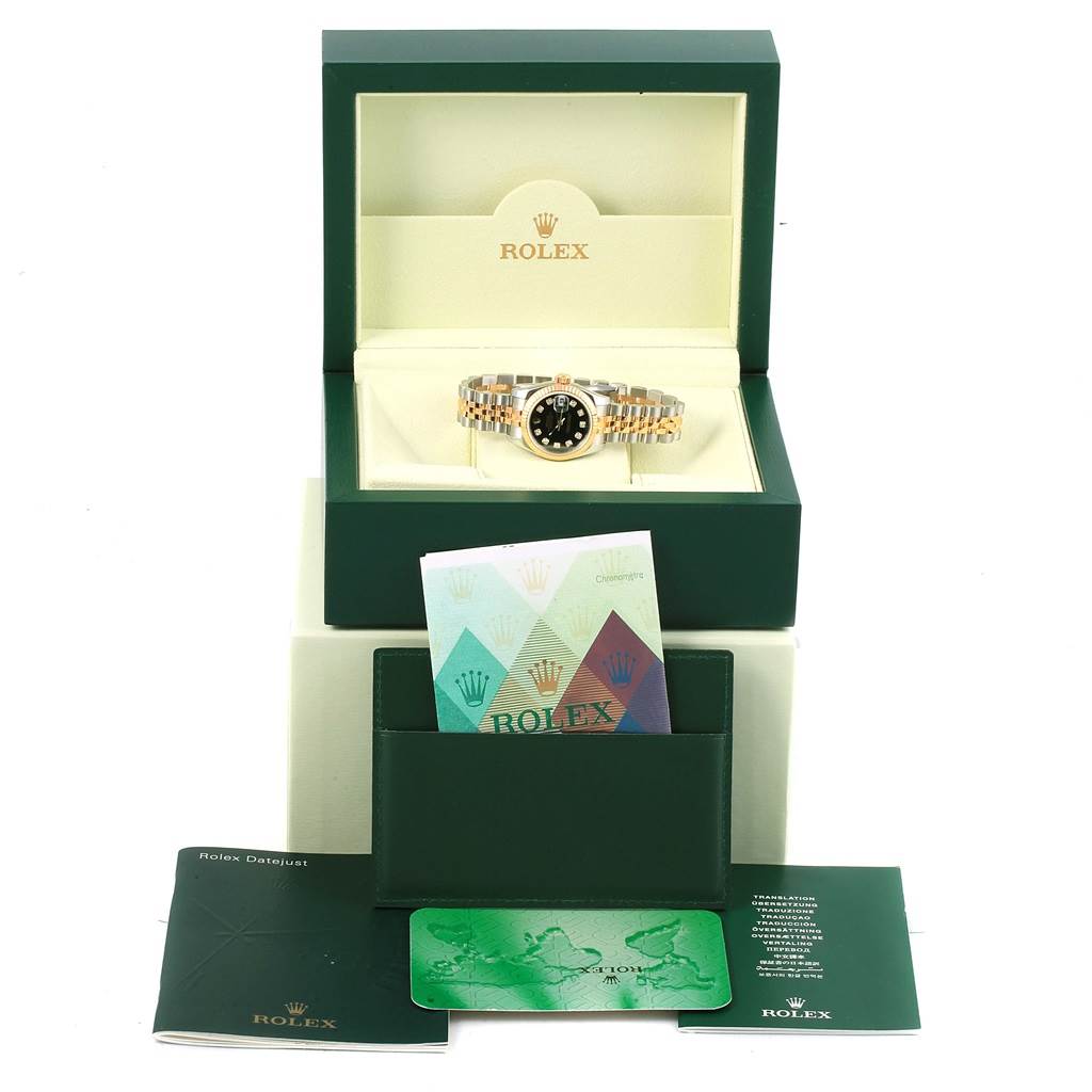 The image shows a Rolex 179173 Men's Steel and Gold (two tone) Black Dial 179173 Men's Steel and Gold (two tone) Black Dial Datejust Steel Yellow Gold Diamond Ladies Watch 179173 with its box, warranty card, and booklet from a frontal angle.