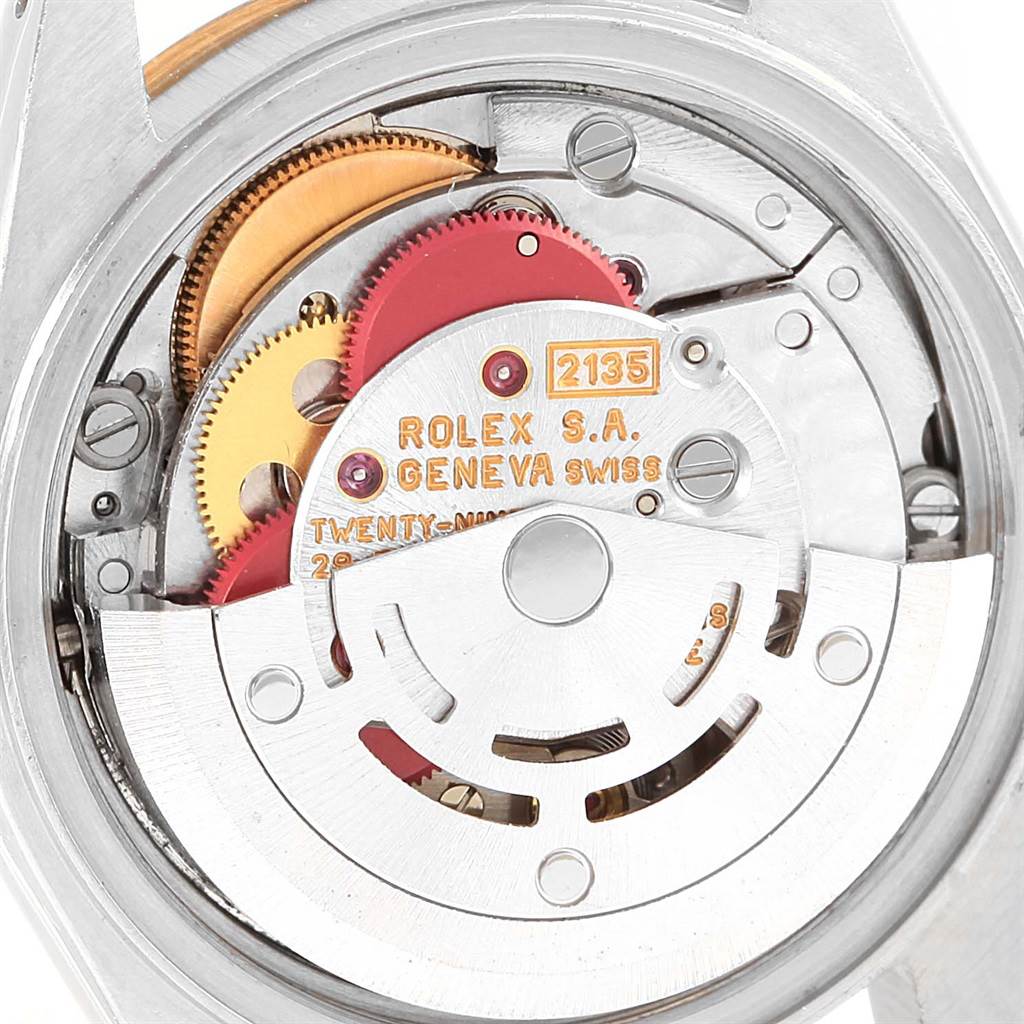 This image shows an internal view of the Rolex Datejust 69163 Women's Stainless Steel Champagne Dial 69163 Women's Stainless Steel Champagne Dial model's movement, displaying gears and inscriptions.